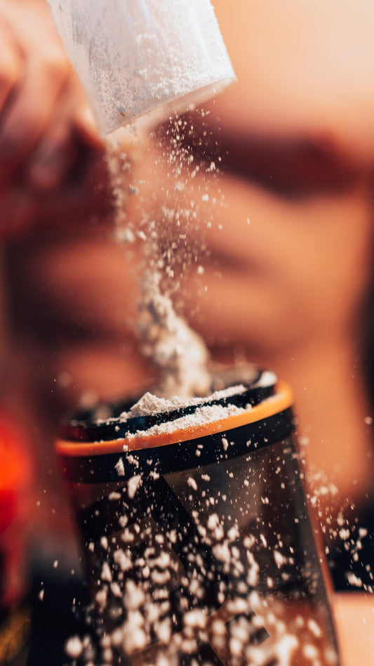 Electrolyte hydration powder being poured into a shaker bottle