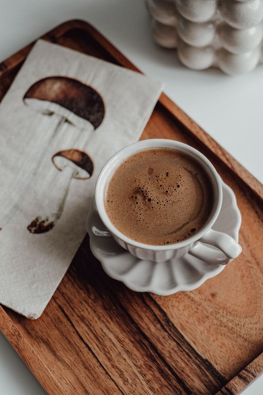Cup of mushroom coffee on a wooden tray with mushroom illustration